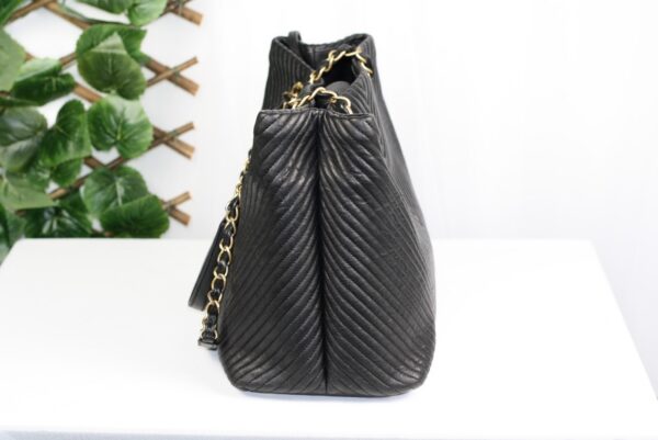 p1-234.jpg Chanel Surpique Chevron Calfskin CC Charm Black Leather Large Shopping Tote